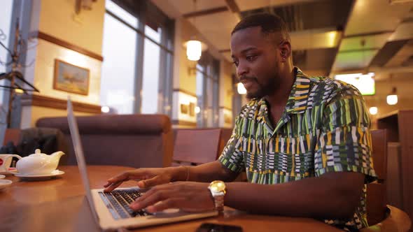 African-American Man Win a Jackpot Looking in Laptop 