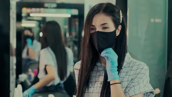 Beautician in Latex Gloves Puts on Protective Mask in Salon