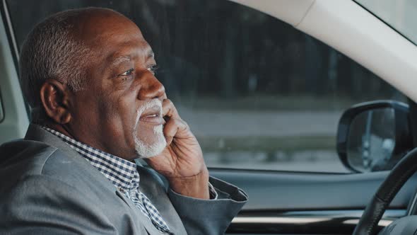 Mature Elderly African American Businessman Sitting in Car Answering Business Mobile Call Confirming alt