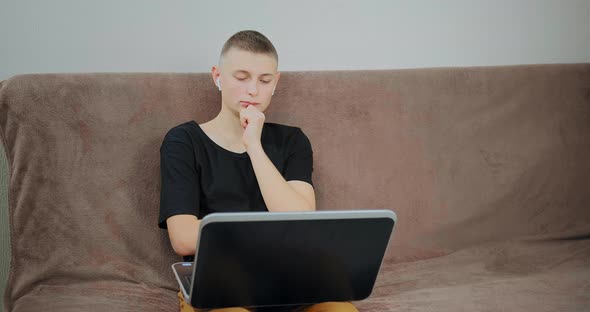 Serious Guy looks into black laptop display at online lesson alt