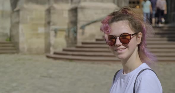 Beautiful Smiling Young Girl with Backpack Walking in Tourist Old City alt