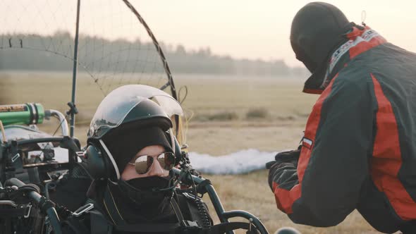 Man Sitting in Paramotor Trike and Concentrating Before Takeoff alt