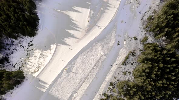 Drone flight over a group of people skiing in the ski resort during winter season alt