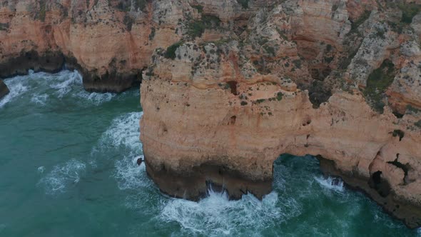 Aerial Drone Tilt Down Above Rocky Cliff Coast in Lagos Algarve Portugal Birds Eye Overhead Top Down alt