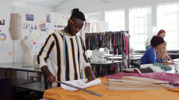 Mixed race man working in creative office alt