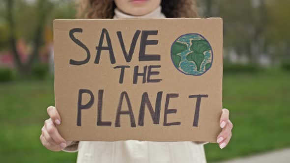 Woman with a Poster SAVE THE PLANET