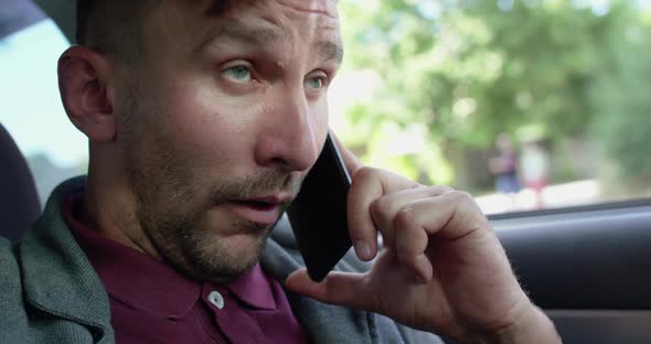 Man in Car Talks on the Phone Gets Mad From the Fever and Sneezes Strongly alt