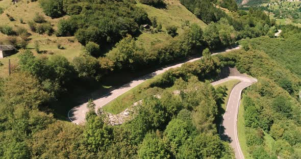 Aerial View Cars and  Motorcycles Driving on Winding Serpentine Road, Switzerland