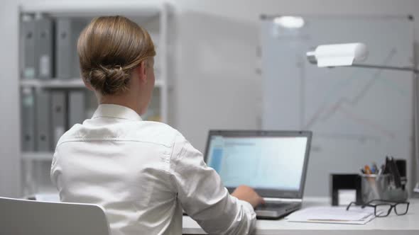 Woman Holding Her Lower Back Trying to Stand Up, Spasms or Nerve Clamp, Backview