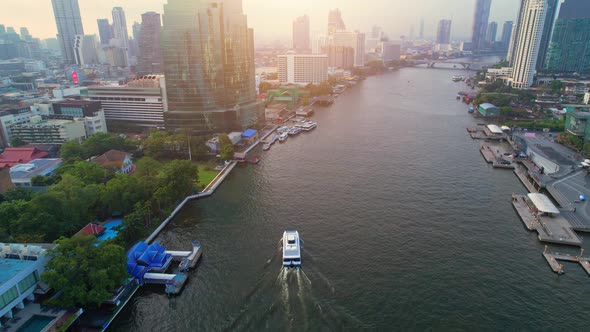 4K UHD : Drones fly over passenger boats moving on the Chao Phraya River alt