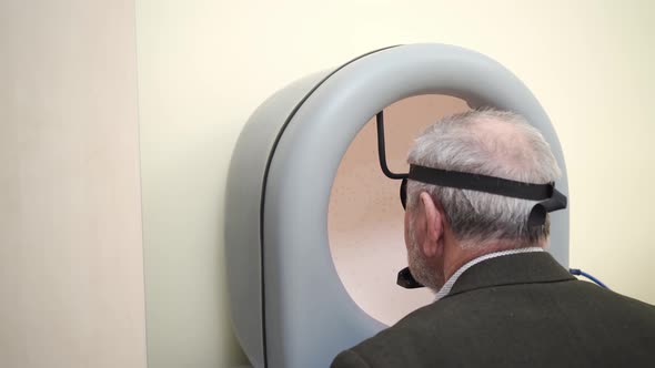 Examination of Elderly Man on on Device Pnr the Perimeter of the Field of View alt