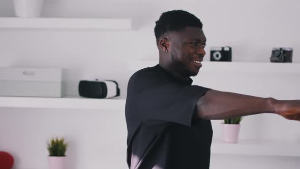 Black Guy Wearing a Fitness Belt Doing Shoulder and Arm Stretches alt