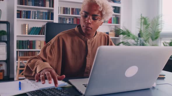Stressed African Woman in Eyewear Looking at Financial Documents Utility Bills alt