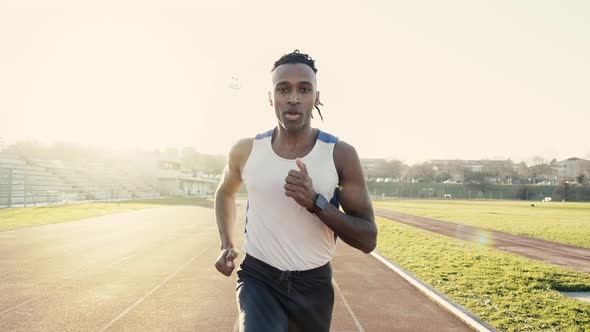 Male athlete run on running track in a stadium