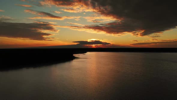 Epic Aerial View of Big Lake With Clear Blue Water. Reflection of Sky and Sun alt