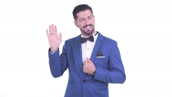 Happy Young Handsome Bearded Businessman Waving Hands alt