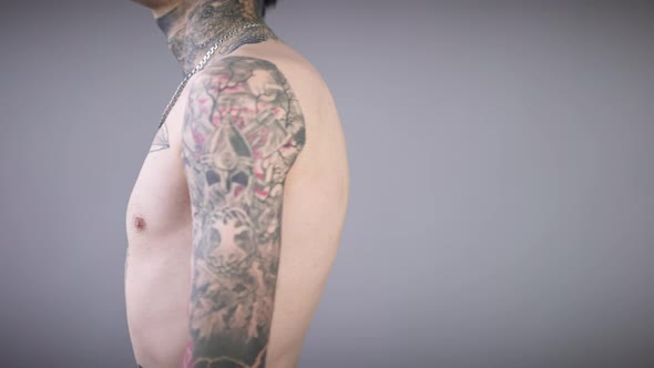 Unrecognizable Tattooed Man Turning Showing Tattoos on Hands Torso and Neck alt