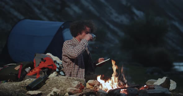 Charismatic Curly Hair Young Guy at Camping Beside alt