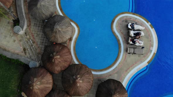 Hotel with a Swimming Pool with Beach Umbrellas Beds at Cancun Mexico alt