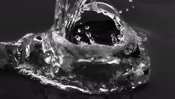 Super Slow Motion Shot of Pouring Water Against Black Background at 1000 Fps. alt