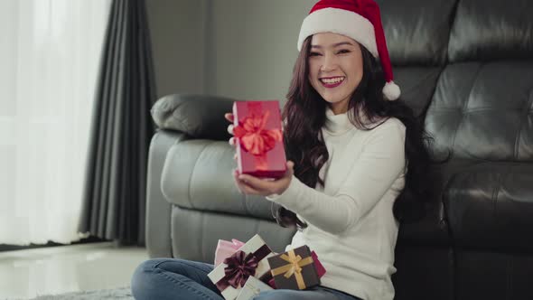 happy woman with Christmas gift in the living room