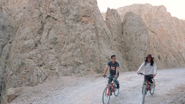 Active Couples Riding Bike Outdoors alt