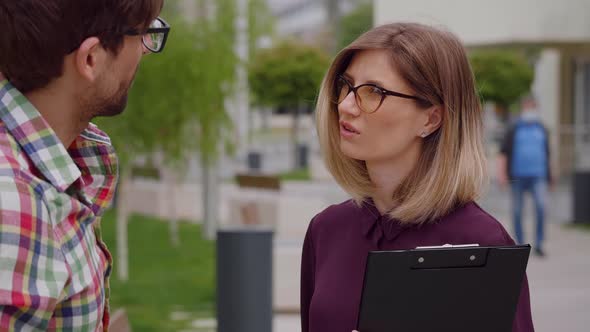 Two young entrepreneurs people talk about projects concentrated faces. alt