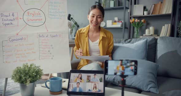 Asia lady english teacher video conference calling on smartphone talk by webcam learn teach. alt
