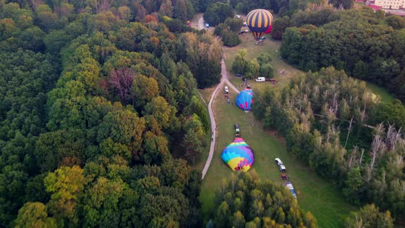 Hot Air Balloons Preparing for Takeoff From Park at Summer Sunrise Hyperlapse  alt