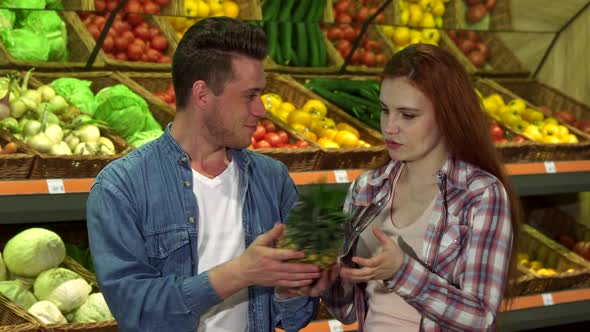 Couple Buys Pineapple at the Supermarket