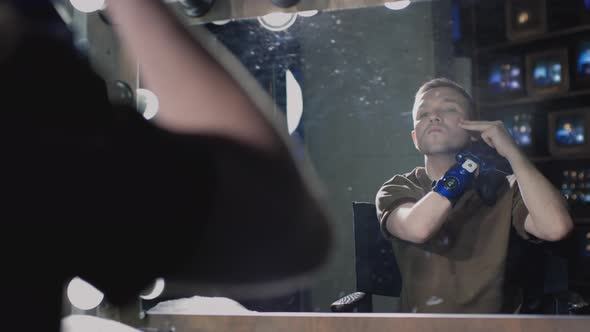 A Disabled Man with a Prosthetic Hand Shaves Cuts His Beard alt