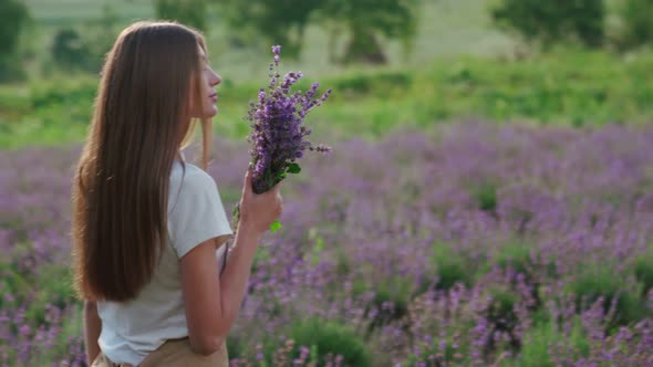 Smiling Woman Posing with Bouquet in Lavender Field alt
