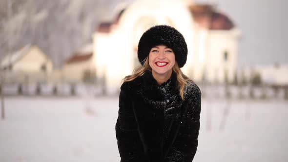 A Woman in a Winter Hat Smiles