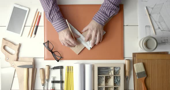 Creative carpenter and designer working at desk