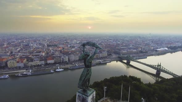 Flying Around of Statue of Liberty with the Skyline of Budapest at Background