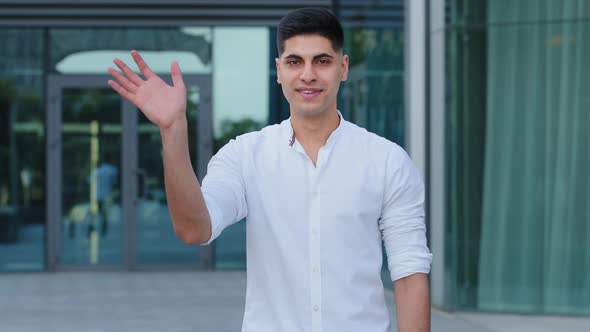 Male Portrait Outdoors Young Indian Arabic Guy Wearing White Shirt Tells you Hello alt