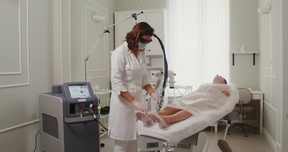 A Dermatologist Doctor Makes a Laser Treatment Procedure for a Patient's Skin alt