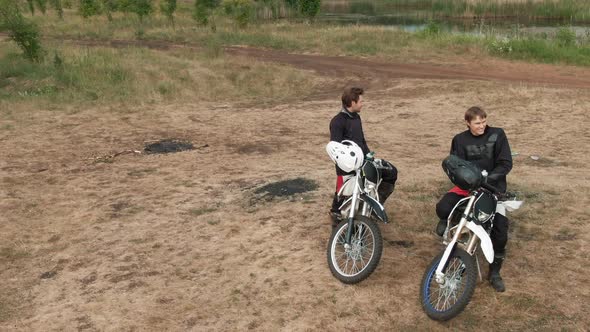 Cheerful Motorcyclists Resting and Enjoying Nature alt