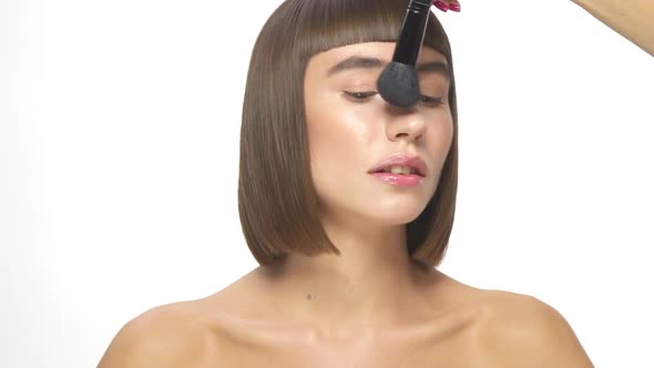 Girl Getting Make-up on White Background alt