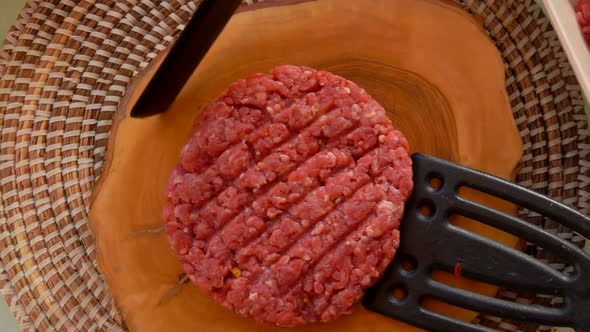Cook Raises Cutlet for Hamburgers with Two Spatula alt