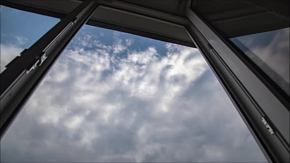 Amazing time lapse: view through window on fluffy clouds floating by the sky