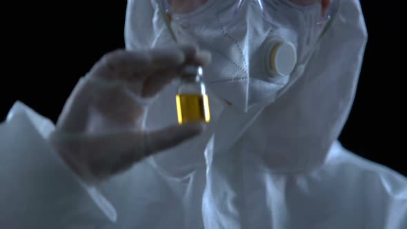 Researcher Showing Bottle With Vaccine to Camera, Poison Antidote Development alt