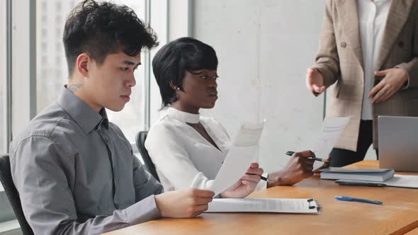 Multiracial Partners Investors African Business Woman and Asian Boss Professional Sitting at Table alt