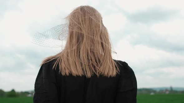 Girl In Black Dress Goes By The Field. alt