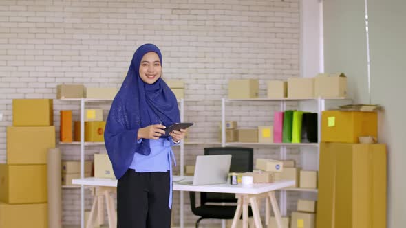 Young Muslim woman with start up small business entrepreneur freelance working at home alt