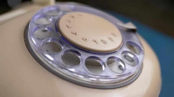 Female Hand Picks Up Phone and Wrong Dial a Number on a Retro Rotary Telephone alt