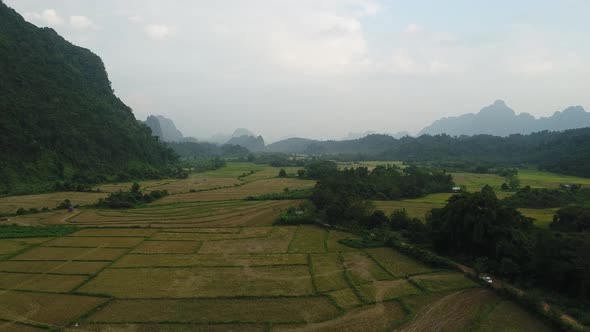 Fields near town of Vang Vieng in Laos seen from the sky alt