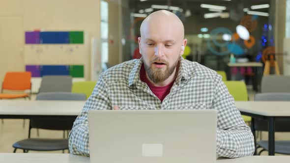 Teacher Who Teaches Online Lessons Sits in Front of the Computer alt