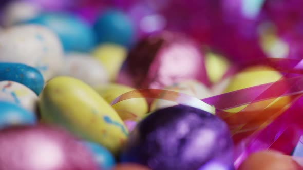 Rotating shot of colorful Easter candies on a bed of easter grass alt