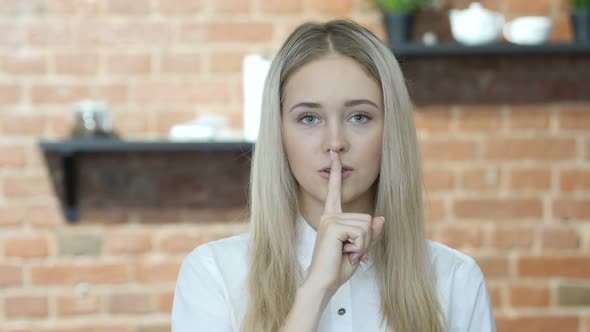 Silent, Young Girl Showing Gesture of Silence alt